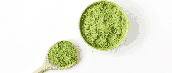 scooping matcha into a container