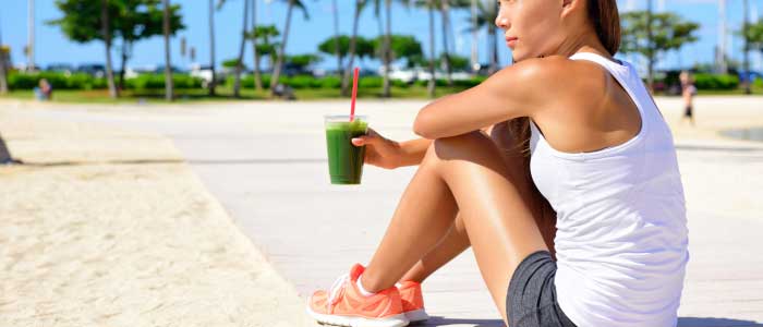 fitness woman sitting down drinking matcha