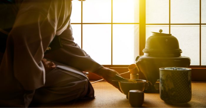 tea master preparing chanoyu with traditional utensils used